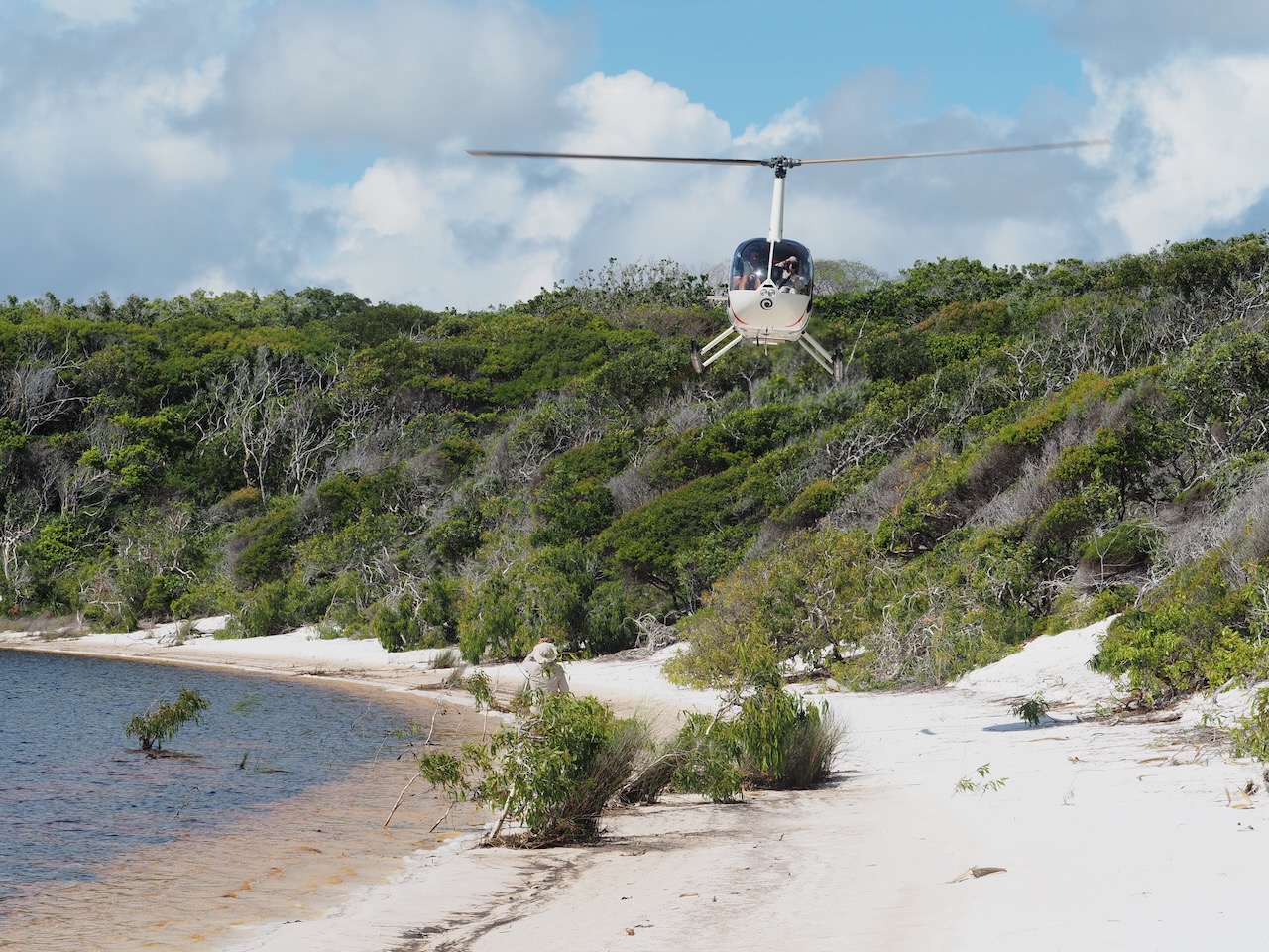 Helicopter crossing turquoise marine channels