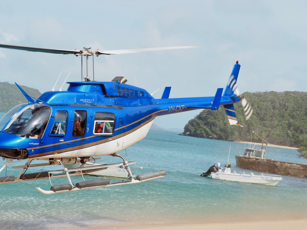 Helicopter parked on beautiful sand bar shoreline